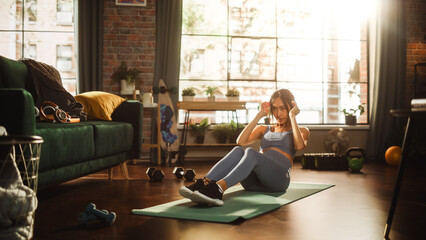 Portrait of a Beautiful Athletic Asian Woman Does ABS Crunches Exercises, Workout, Yoga, Stretching, Training at Home. Sunny Apartment with Positive Smiling Healthy Woman Staying Mindful.