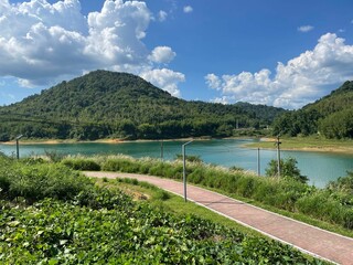 Poster - Cloudy sky over hilly terrain and lake