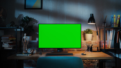 Wall Mural - Desktop Computer Monitor with Mock Up Green Screen Standing on a Wooden Desk with Height Adjustable Function. Chroma Key Display at Home in Modern Living Room or Creative Loft Office with Brick Wall.