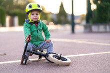 Boy In Protective Helmet Sitting On Bicycle