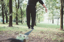 Close Up Man Training Walking Tightrope Practicing Slacklining Outdoors Garden