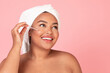 © Prostock-studio - Close up shot of black obese woman using serum in her face care routine, recommending nice beauty product, copy space