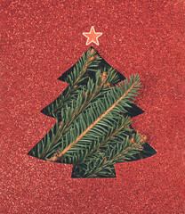 Christmas tree card with red cutout glitter paper and spruce branches bursting through. Holiday, Xmas spirit minimal background.