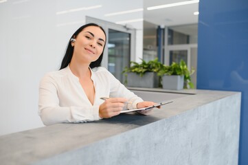 Wall Mural - Picture of pretty receptionist at work.