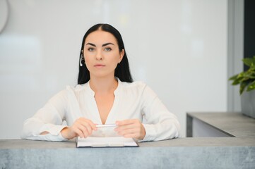 Wall Mural - Picture of pretty receptionist at work.