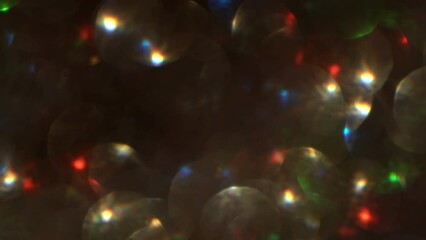 Canvas Print - Glowing Lights Fly on a Bokeh Background. Movement of illuminated shiny dots against the background of soft defocused circles. Abstract moving 4K background. Natural Lens Flare effect.