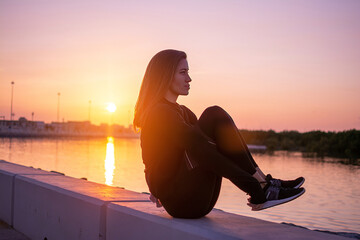 Young fit woman doing butt balance exercise outdoors.