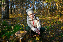 Mom And Child Girl Walk In The Forest In Autumn And Pick Mushrooms.