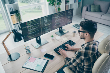 Photo of handsome cool guy wear glasses creating new start up modern device indoors workstation workshop home