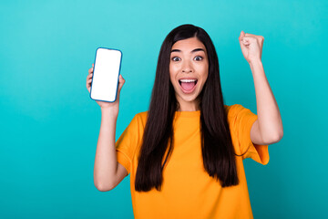 Wall Mural - Photo of hooray young lady show telephone yell wear orange t-shirt isolated on teal color background