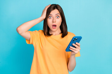 Wall Mural - photo of confused speechless person arm touch head open mouth hold telephone isolated on blue color 
