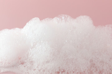 Poster - Fluffy bath foam on pink background, closeup