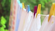 Drying Laundry On The Clothesline Close Up. Clean Laundry Hanging On A Clothesline. Clean Washed Laundry Hooked With Clothespin Hanging To The On Clothesline