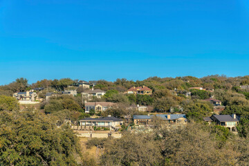 Wall Mural - Austin, Texas- Facade of large house buildings surrounded by green trees near Lake Austin