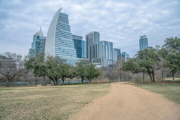 Wall Mural - Path in the middle of grassland with trees near Colorado River at Auditorium Shores Park- Austin, TX