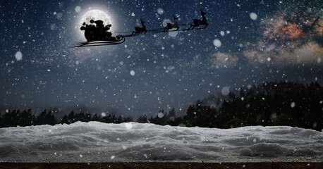 Wall Mural - Santa Claus flies on Christmas Eve in the night sky with snow