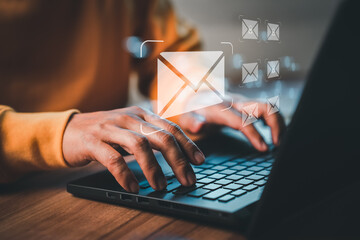 freelancer's hand using computer laptop and sending online message with email icon, email marketing 
