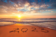 Leinwandbild Motiv Happy New Year 2023 ocean sunrise on the beach shore concept