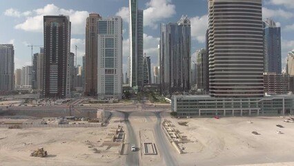 Wall Mural - Flying in the middle of Dubai Marina skyscrapers on a sunny day, time lapse