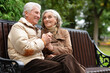 © aletia2011 - Beautiful elderly couple sitting together on a bench in autumn
