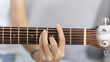 © Puwasit Inyavileart - Close up fingers playing guitar strings, Strum to make a sound, Acoustic guitar, Catching guitar chords to create music, Music therapy and meditation practice with playing the guitar.