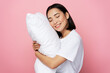 © speed300 - Photo portrait of gorgeous girl hugging pillow with closed eyes isolated on pink