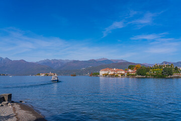 Canvas Print - Ferry at the lake Maggiore, landscapes over the lake, in the background Isola Bella - island Bella in Italy