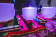 Big quartz singing bowls, chime bells and tingsha cymbals over a andean (peruvian) handwoven with purple light