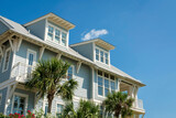 Fototapeta Mapy - Low angle view of a house with light blue wood sidings and white trims at Destin, Florida