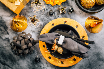 Sticker - Glamorous black and gold place setting with modern plates for New Years Eve and Christmas