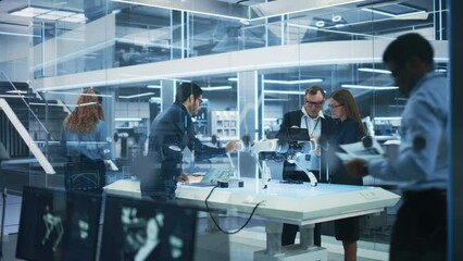 Leinwandbilder - Young Team of Multicultural Engineers Use Tablet and Laptop Computers, Analyze and Discuss How a Futuristic Robot Dog Works. High Tech Research Laboratory with Modern Equipment.