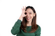 © Parichat - Portrait happy Asian woman shows ok sign and looking at the camera isolated on white background.