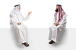 © Ljupco Smokovski - Two arab men seated on a white panel having a conversation