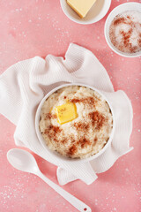 Wall Mural - rice pudding with butter cinnamon. french riz au lait, norwegian risgrot, traditional breakfast dessert