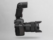 © splitov27 - Modern digital dslr camera with lens and flash levitating on gray background with shadow