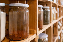 Glass Jars Of Various Spices On Shelves