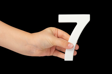 Aufkleber - Number seven in hand isolated on black background. Number 7 in a child's hand on a black background. To be inserted into a project or design.