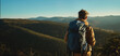 Panoramic view of mountains and hills at sunset, back view man hiker with backpack admiring landscape, travel point destination