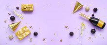Party Hats, Christmas Gifts, Balls, Glasses And Champagne On Lilac Background With Space For Text