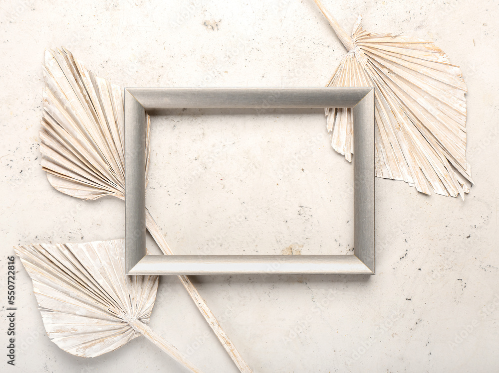 Frame with dried leaves on white background