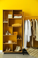Wall Mural - Interior of stylish dressing room with rack, clothes and shelving unit