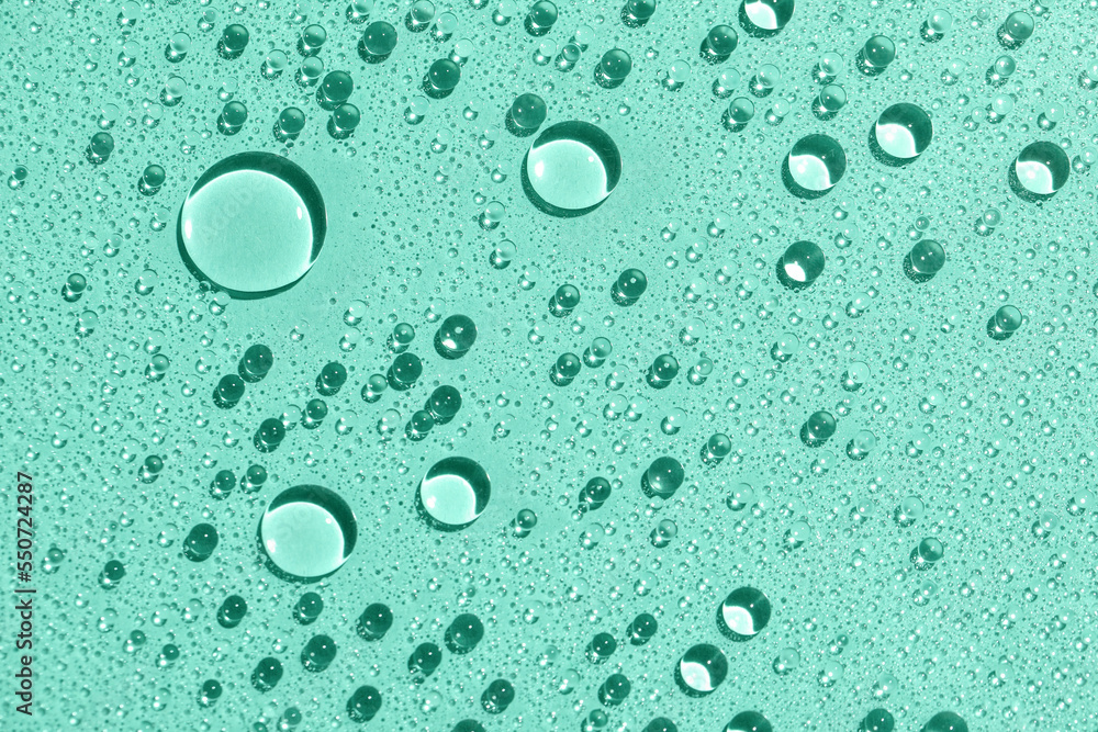 Closeup view of water drops on mint background