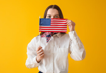 Canvas Print - Young woman with USA flag on yellow background