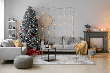 Canvas Print - Interior of living room with glowing Christmas tree, sofas and clock