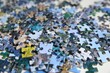 © New Africa - Jigsaw puzzle pieces on table, closeup view