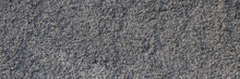 The Texture Of The Gray Wall. Decorative Plaster.  Rough Grainy Bumpy Surface. Wide Panoramic Texture For Background And Design.