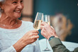 © Anela/peopleimages.com - Senior couple, champagne and toast at restaurant, having fun and bonding. Love, cheers and retired man and woman with glass of wine for celebration, anniversary or birthday and enjoying time together