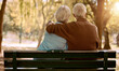 © Anela/peopleimages.com - Love, hug and old couple in a park on a bench for a calm, peaceful or romantic summer marriage anniversary date. Nature, romance or back view of old woman and elderly partner in a relaxing embrace