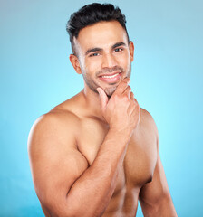 Poster - Portrait, wellness and man with smile, skincare and natural beauty on blue studio background. Latino male, healthy gentleman and cosmetics for body care, confidence and organic facial for face detox.