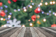 Empty wood table top with blur Christmas tree with bokeh light background